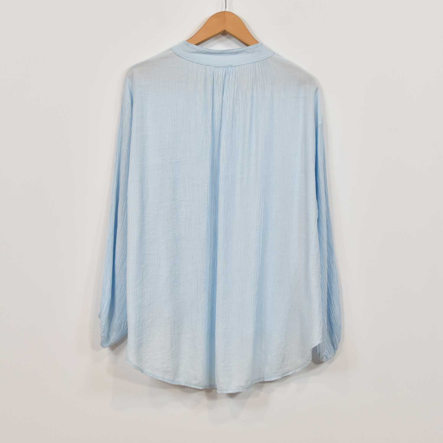 Light blue ruffled blouse